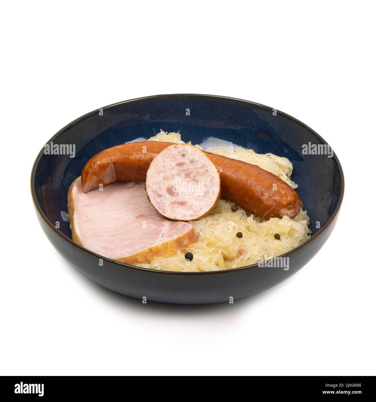 plate of garnished sauerkraut on white background - studio shot Stock Photo