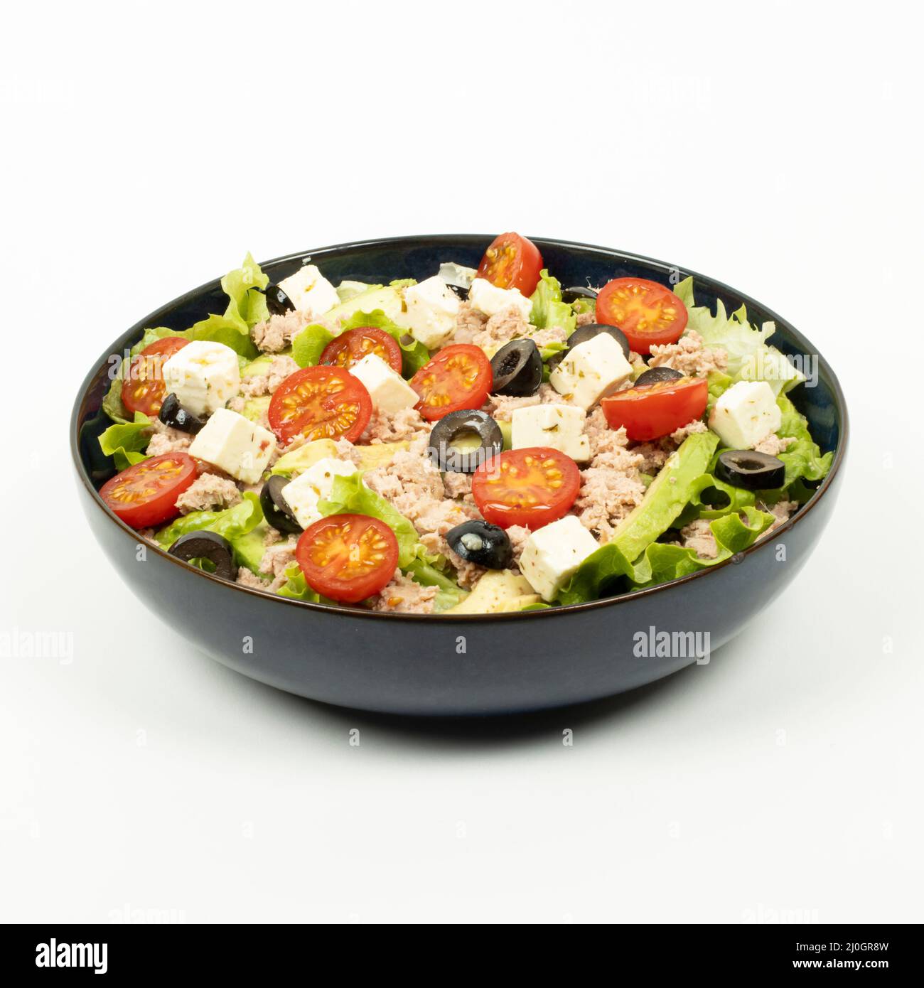 salad, avocado, tuna, tomatoes, feta in a bowl on a white background - studio shot Stock Photo
