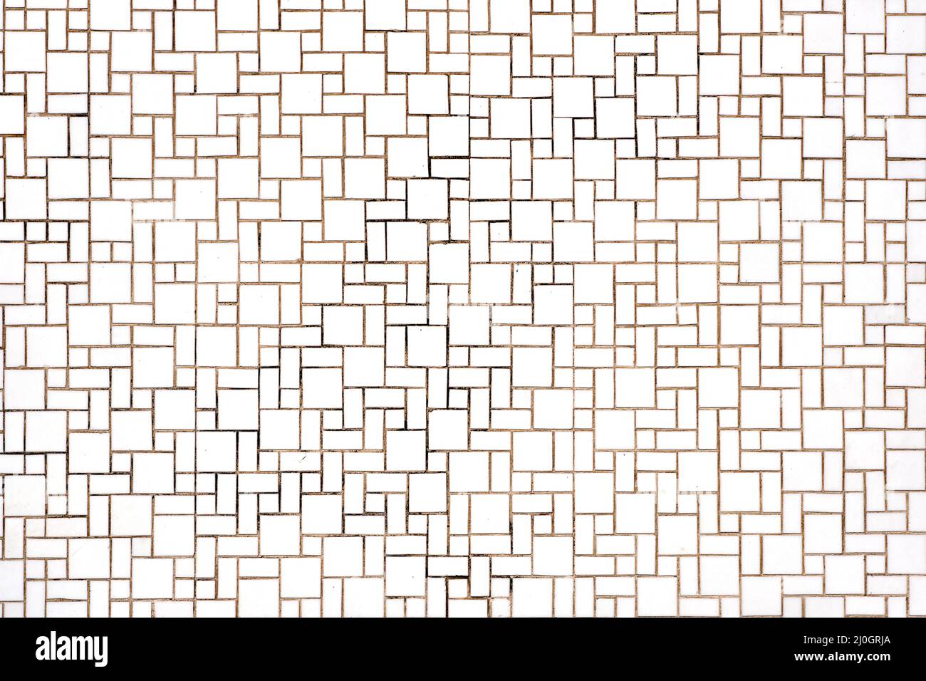 Background from a wall made of rectangular and square white mosaic tiles Stock Photo