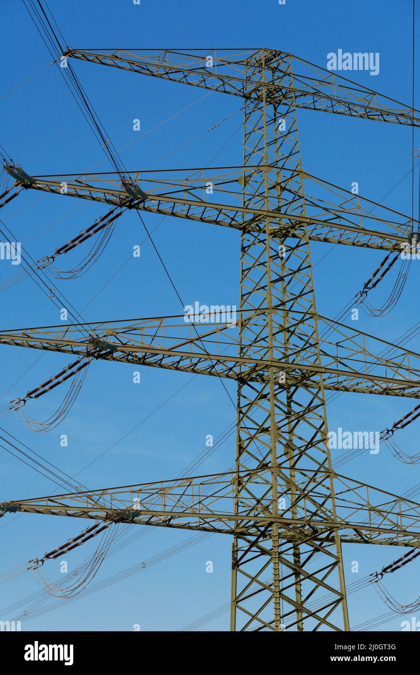 Modern power pole with overhead lines, portrait format Stock Photo