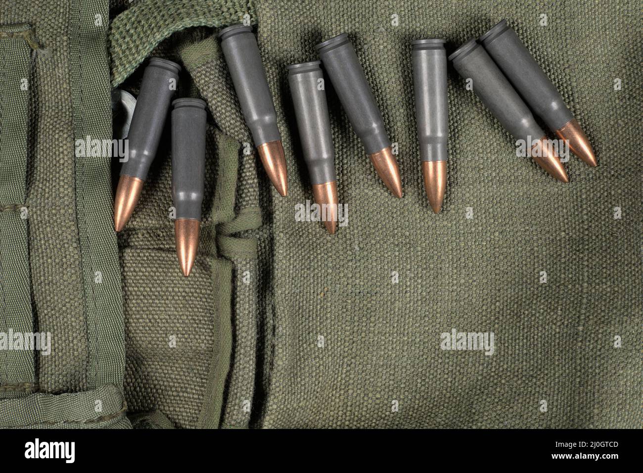 Ak-47 (7,62x39mm) ammunition lying on a piece of military canvas Stock Photo