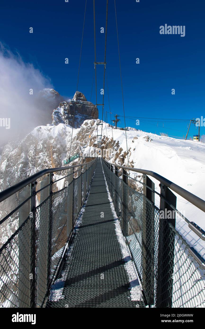 Austrias highest suspension bridge in the austrian Alps. Skywalk on Dachstein. Schladming, Styria, Austria  Spectacular winter landscape and breathtak Stock Photo