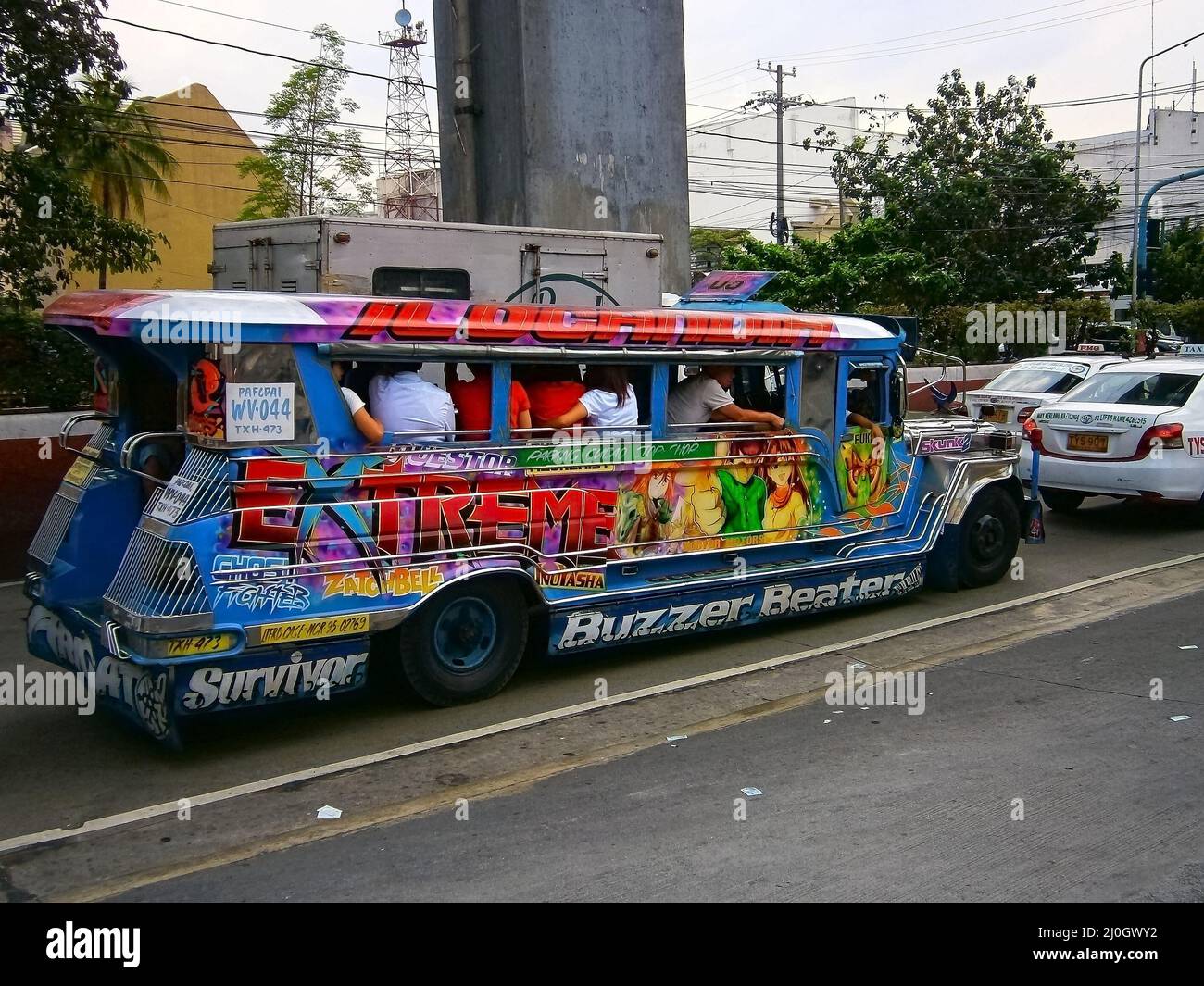 A colourful Jeepney truck in traffic on a busy main road in Quezon city Stock Photo Alamy