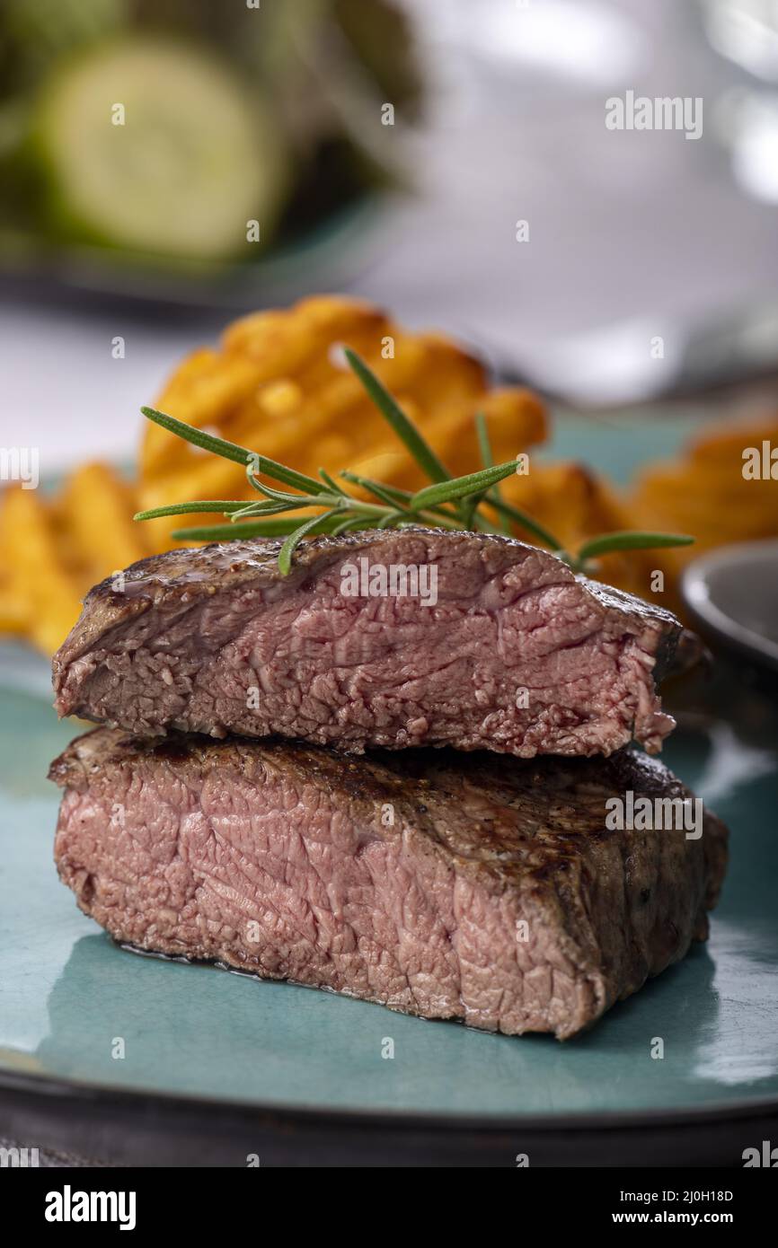 Grilled steak with fresh potato grids Stock Photo