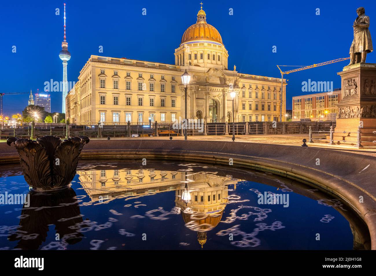 The reconstructed Berlin City Palace and the famous TV Tower at night Stock Photo