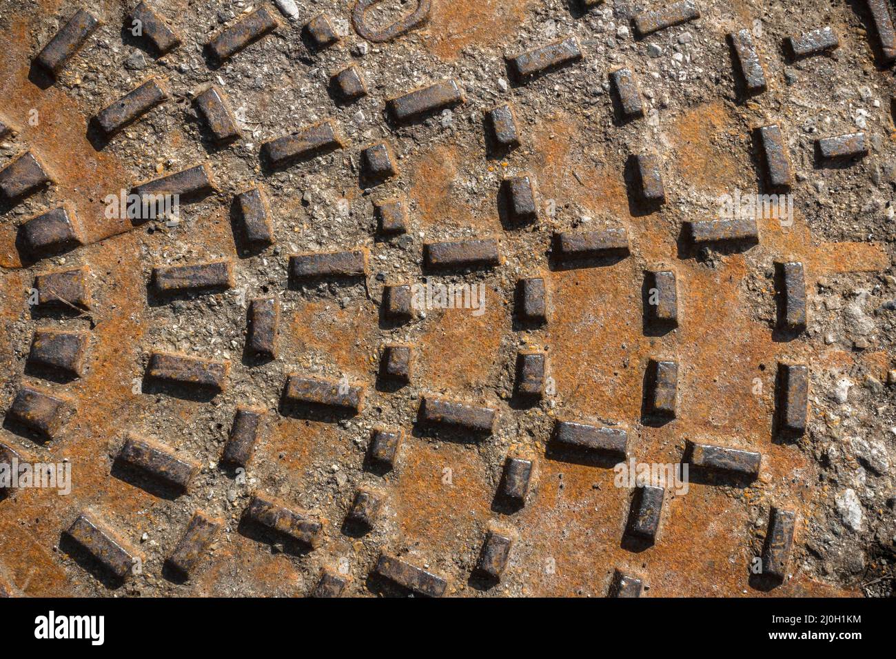 Rusty sewer manhole cover Stock Photo