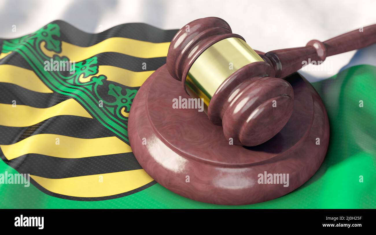 Judge's gavel on the flag of Saxony Stock Photo