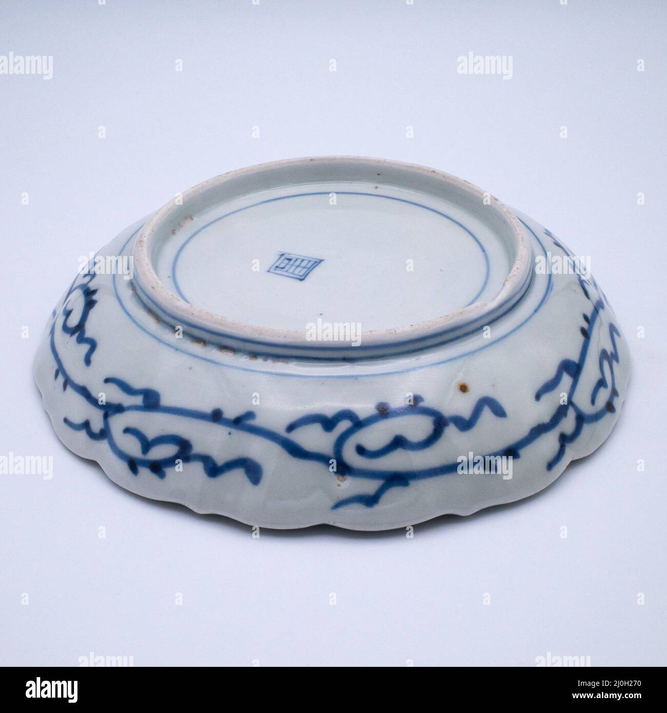Antique Japanese Arita Aoki Kyodai Shokai Blue & White Porcelain Scalloped Dish (REVERSE / FOOT RIM DETAIL) Stock Photo