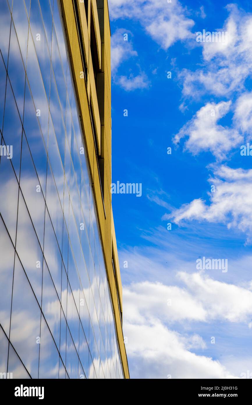 Vertical shot of a modern building in a glass facade with the ...