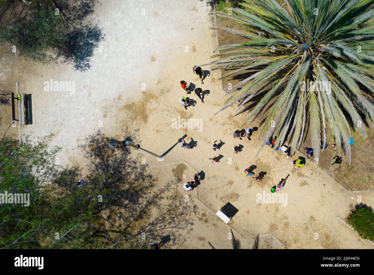 Unrecognised children playing with water in the park. Aerial view of people having fun Stock Photo