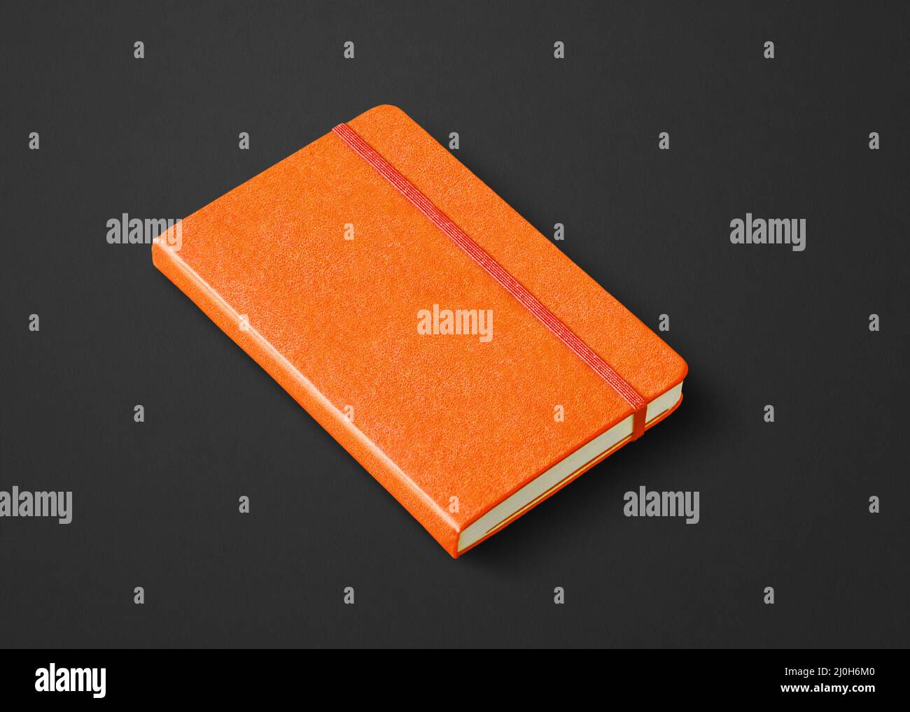 Orange closed notebook isolated on black Stock Photo