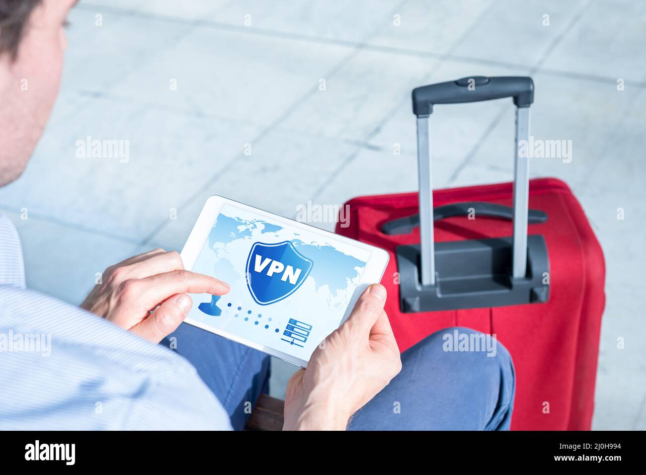 VPN secure connection for business travel. Person using Virtual Private Network technology on tablet computer to create encrypted tunnel to remote ser Stock Photo
