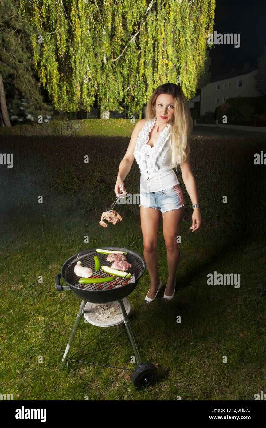 Woman with grill Stock Photo