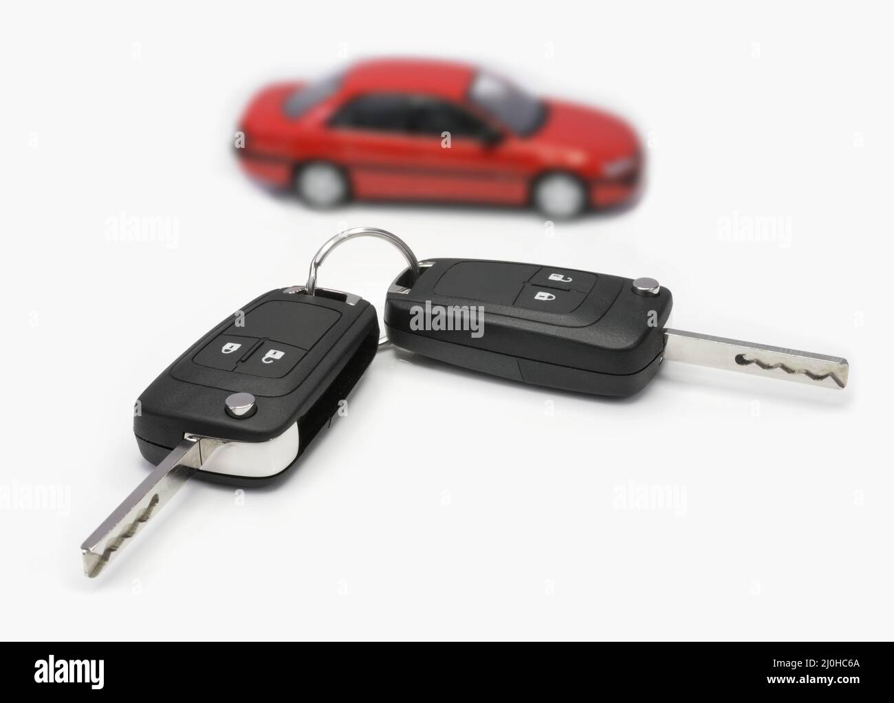 Ignition keys with car in the background Stock Photo