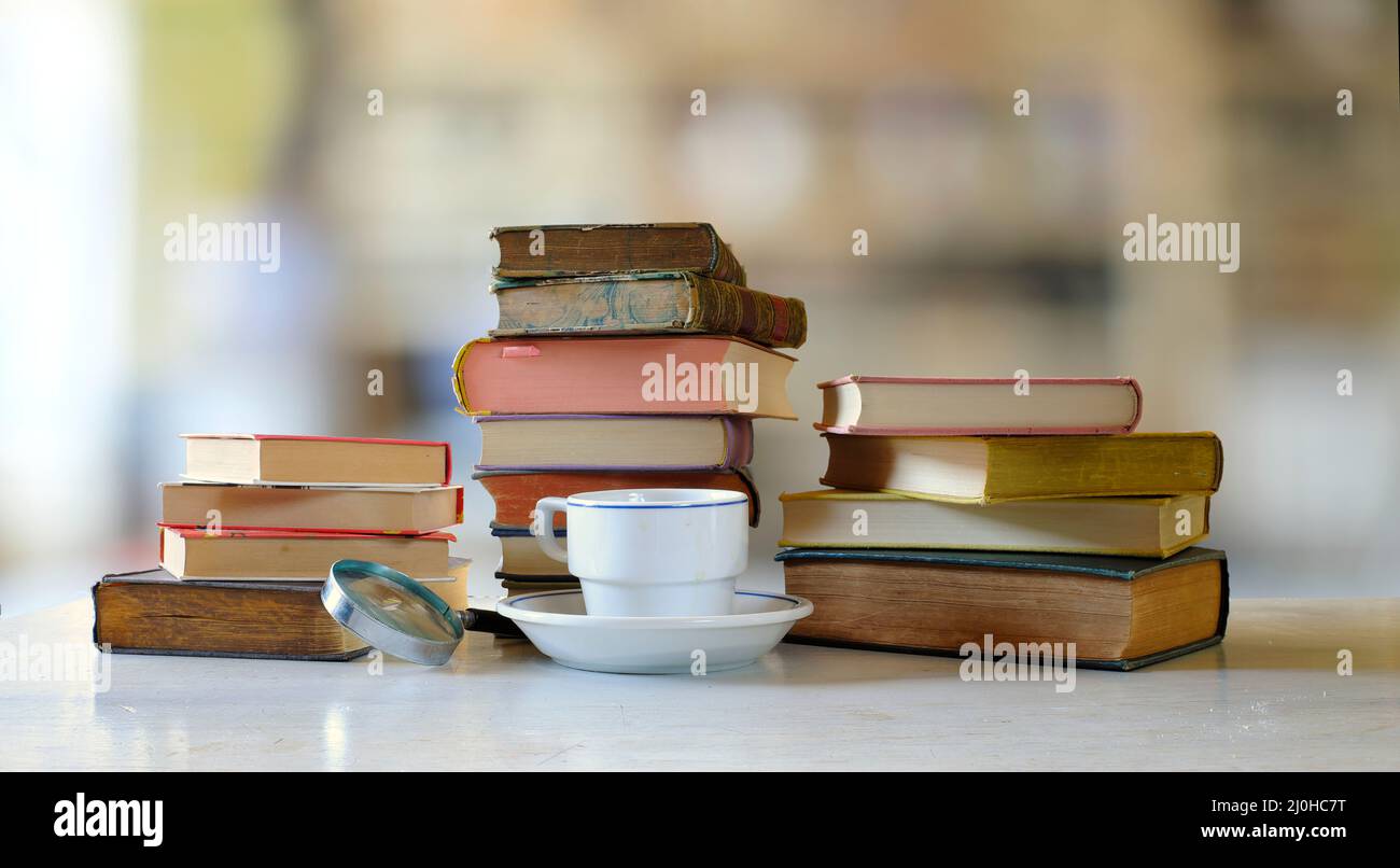 home office,education,business,concept with  heap of books and cup of coffee,blurred background, free copy space Stock Photo