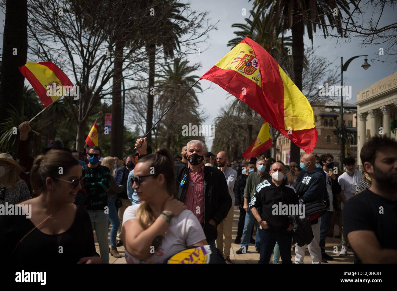 A supporter of far right Vox party is seen waving a Spanish flag as he takes part in a protest against rising fuel prices and Spanish government outside Malaga town hall. Spain experiences a general strike of truck drivers due to rise of prices in fuel and costs in other essential sectors causing discomfort between Spaniards and several protests in the country by political party VOX. The Spanish transport sector continues for sixth consecutive days in strike causing a shortage in some essential products in supermarkets. Stock Photo