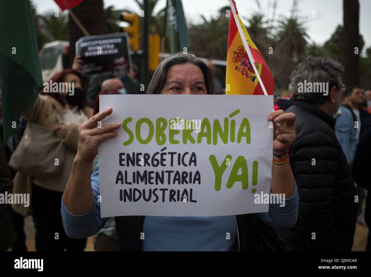 A supporter of far right Vox party is seen holding a placard expressing her opinion, during a protest against rising fuel prices and Spanish government outside Malaga town hall. Spain experiences a general strike of truck drivers due to rise of prices in fuel and costs in other essential sectors causing discomfort between Spaniards and several protests in the country by political party VOX. The Spanish transport sector continues for sixth consecutive days in strike causing a shortage in some essential products in supermarkets. Stock Photo