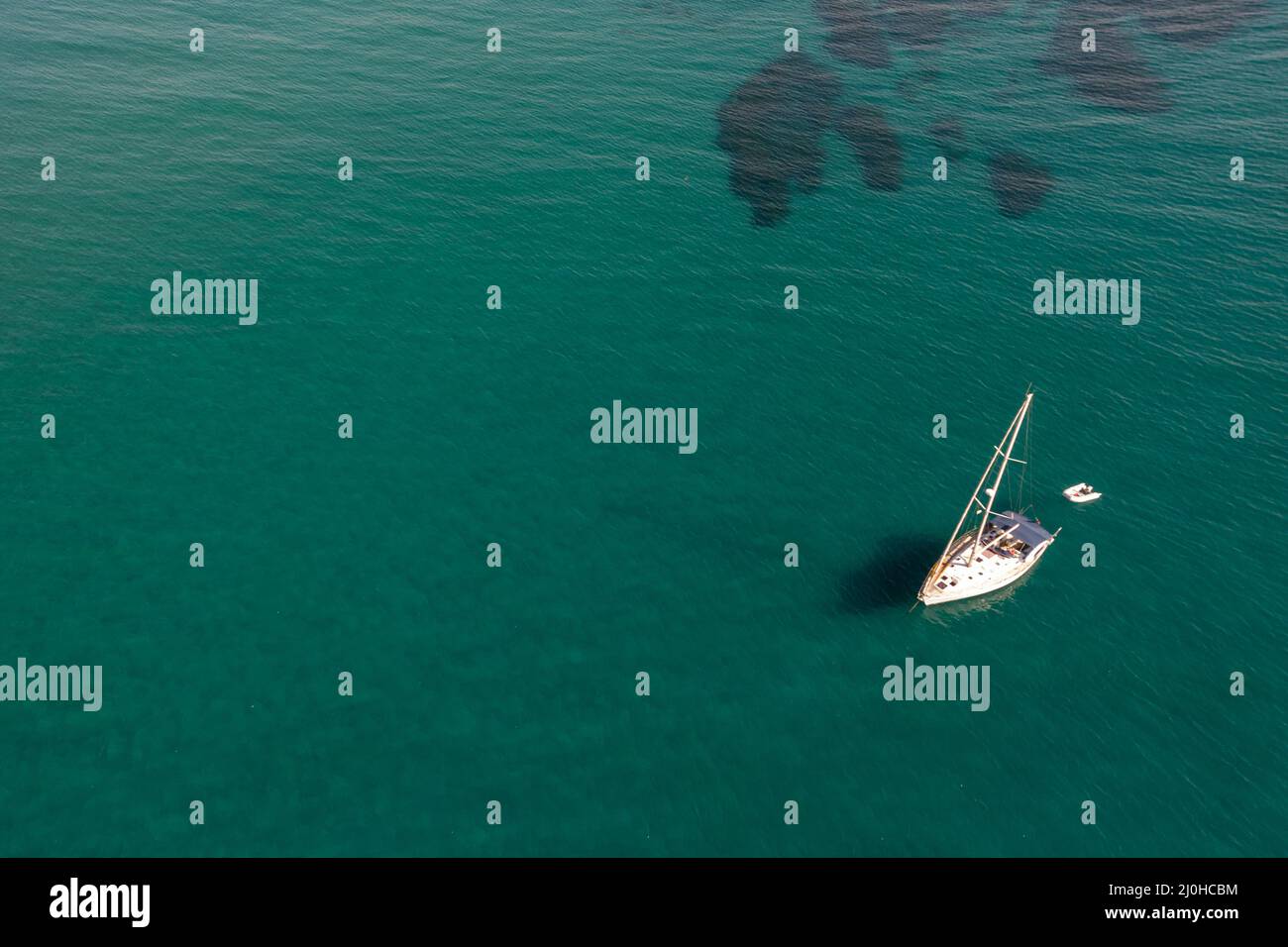 Aerial view of a luxury yacht anchored in the surface of the sea ...