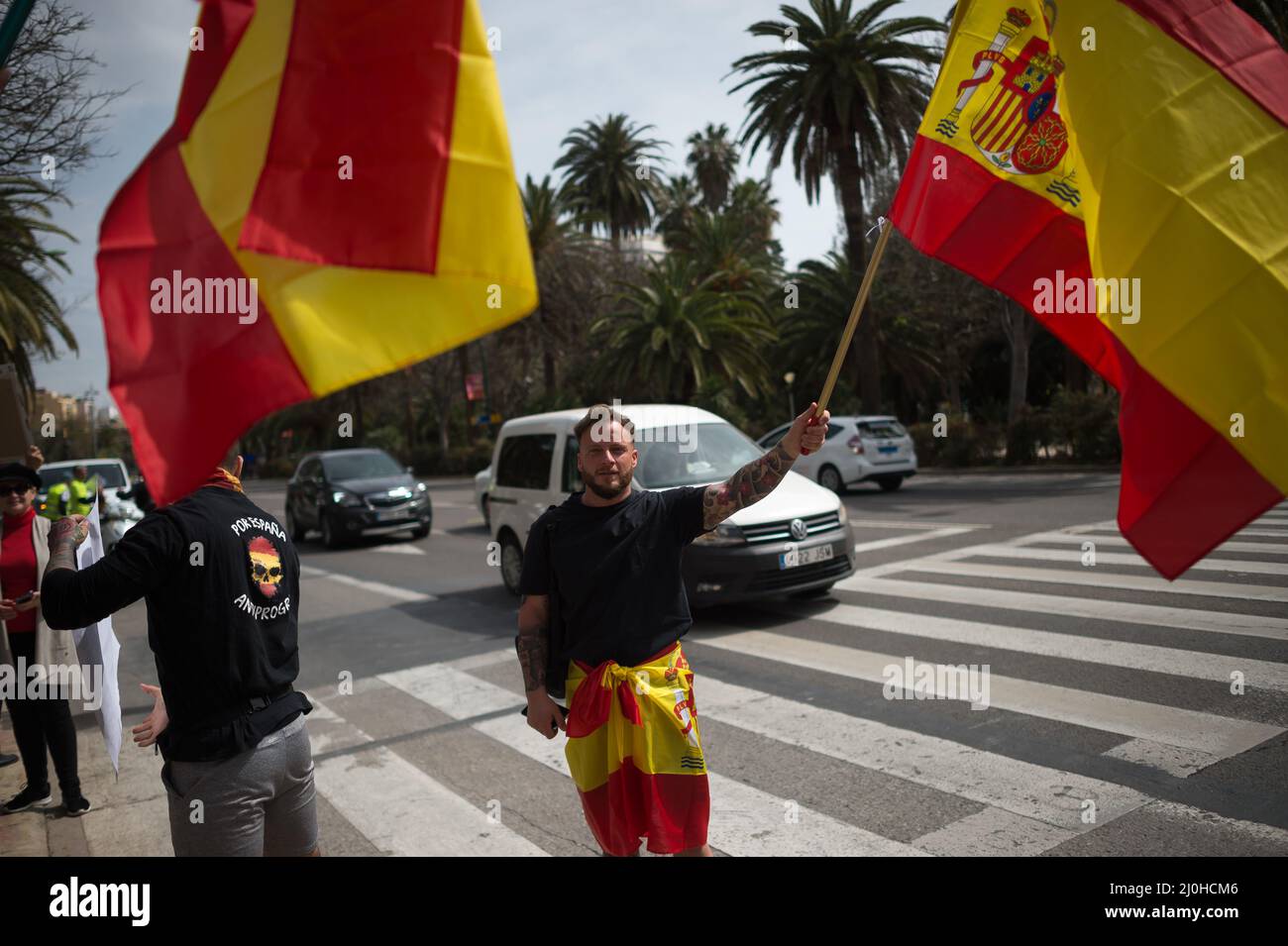 A supporter of far right Vox party is seen waving a Spanish flag as he takes part in a protest against rising fuel prices and Spanish government outside Malaga town hall. Spain experiences a general strike of truck drivers due to rise of prices in fuel and costs in other essential sectors causing discomfort between Spaniards and several protests in the country by political party VOX. The Spanish transport sector continues for sixth consecutive days in strike causing a shortage in some essential products in supermarkets. (Photo by Jesus Merida/SOPA Images/Sipa USA) Stock Photo