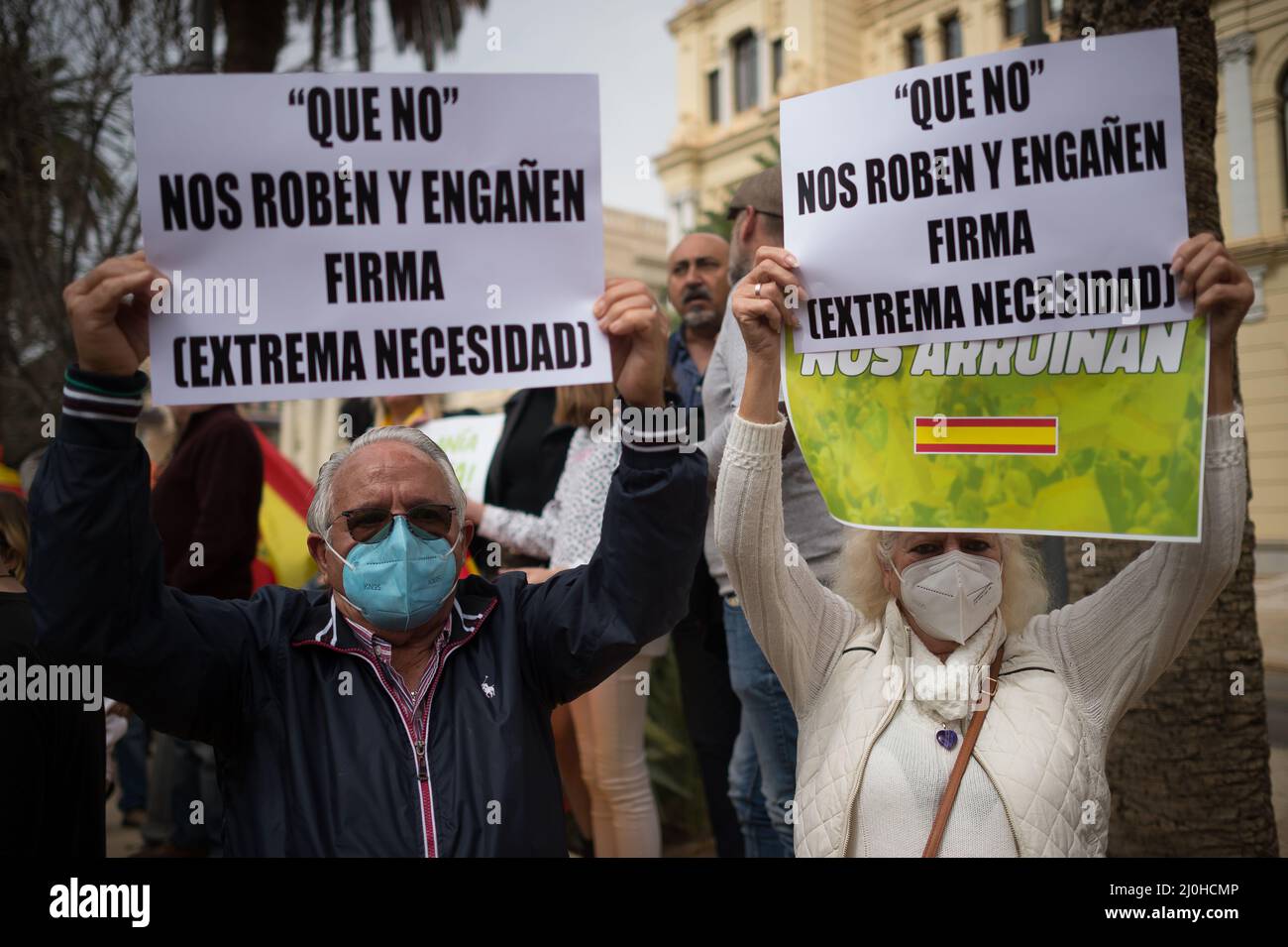 Supporters of far right Vox party are seen holding placards as they take part in a protest against rising fuel prices and Spanish government outside Malaga town hall. Spain experiences a general strike of truck drivers due to rise of prices in fuel and costs in other essential sectors causing discomfort between Spaniards and several protests in the country by political party VOX. The Spanish transport sector continues for sixth consecutive days in strike causing a shortage in some essential products in supermarkets. (Photo by Jesus Merida/SOPA Images/Sipa USA) Stock Photo