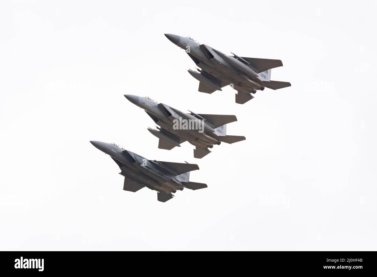 United States Air Force McDonnell-Douglas Three F-15E Strike Eagles fly in a tight formation and perform high alpha manoeuvres. RAF Fairford Stock Photo