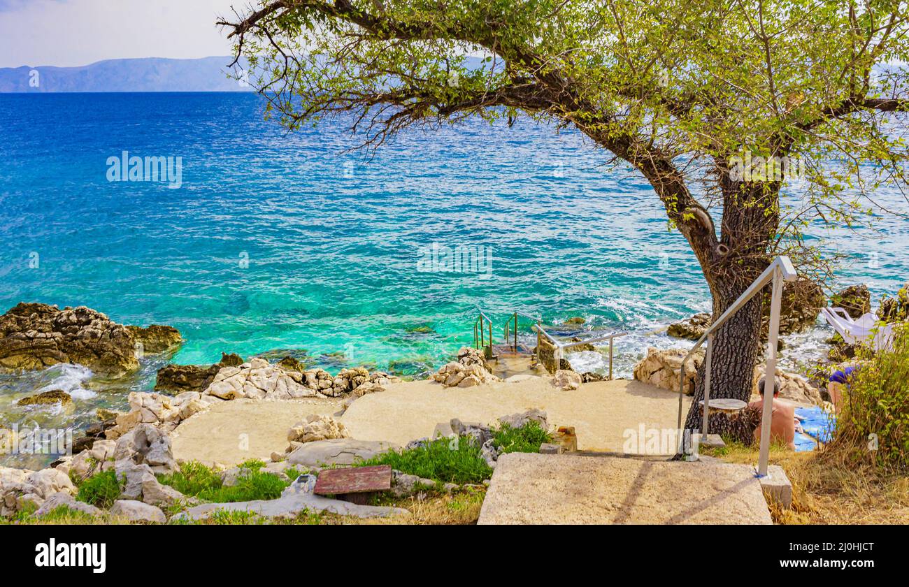 Beautiful Mediterranean landscape in Novi Vinodolski Croatia behind a tree. Stock Photo