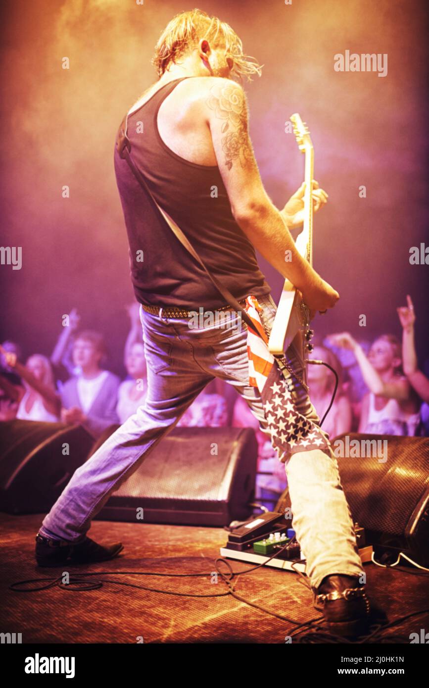 Full length shot of a musician playing guitar for a crowd at a gig. This concert was created for the sole purpose of this photo shoot, featuring 300 Stock Photo