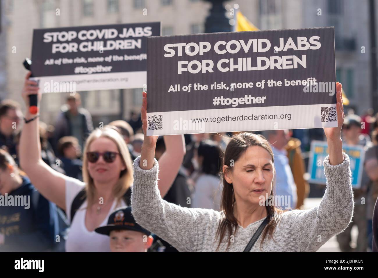 Westminster, London, UK. 19th Mar, 2022.A protest is taking place against vaccinating children for Covid 19, joined by anti-vaxxers. Stop covid jabs for children placard. All of the risk, none of the benefit. #together Stock Photo