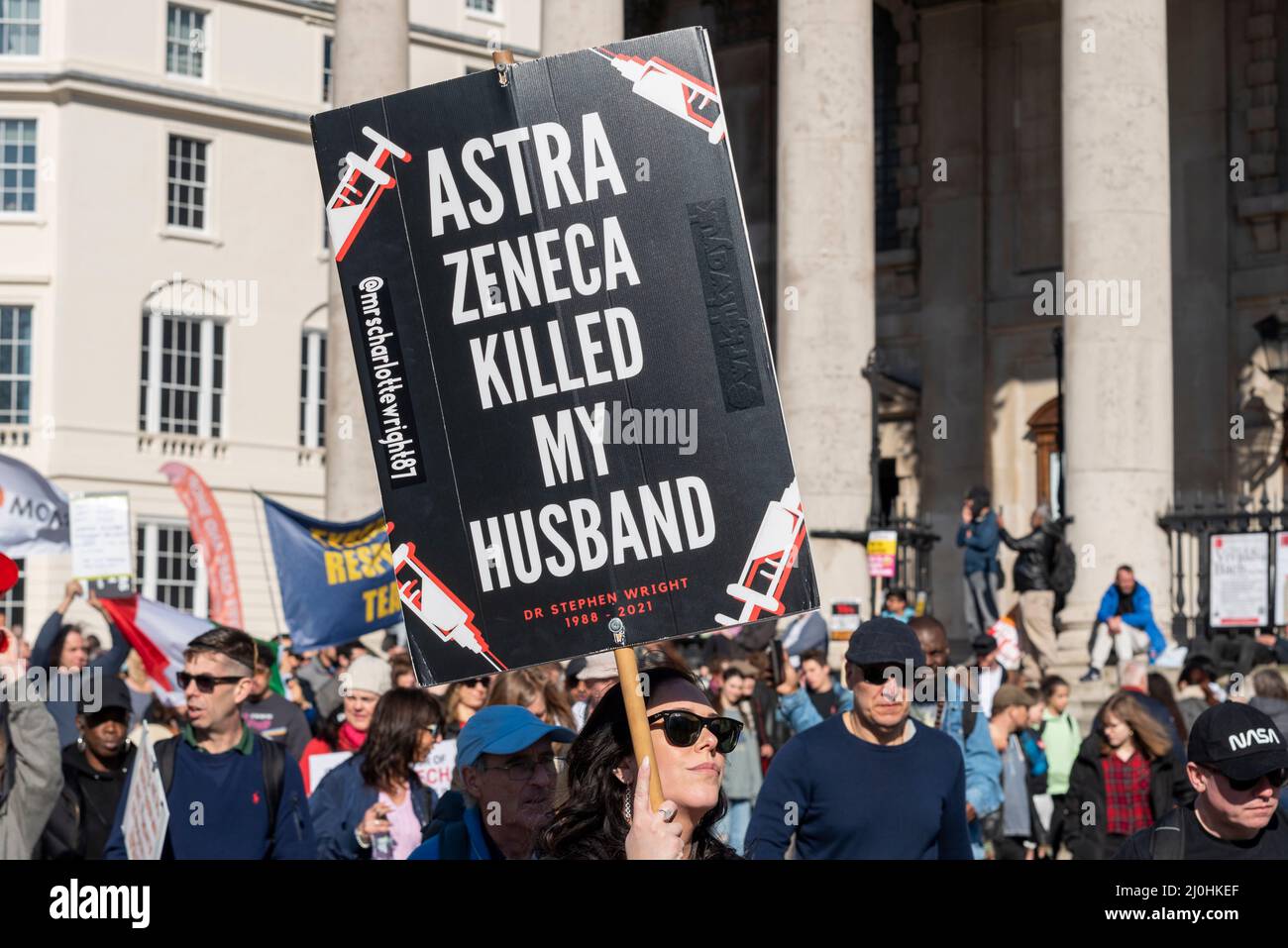 Westminster, London, UK. 19th Mar, 2022.A protest is taking place against vaccinating children for Covid 19, joined by anti-vaxxers. Female with placard stating Astra Zeneca killed my husband Stock Photo