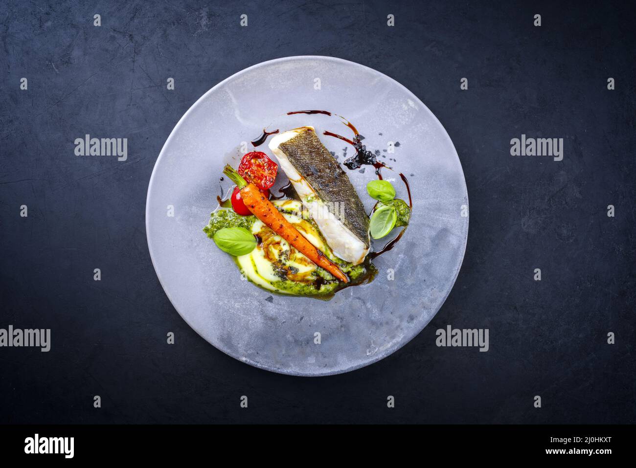 Modern style traditional fried skrei cod fish filet with mashed potato