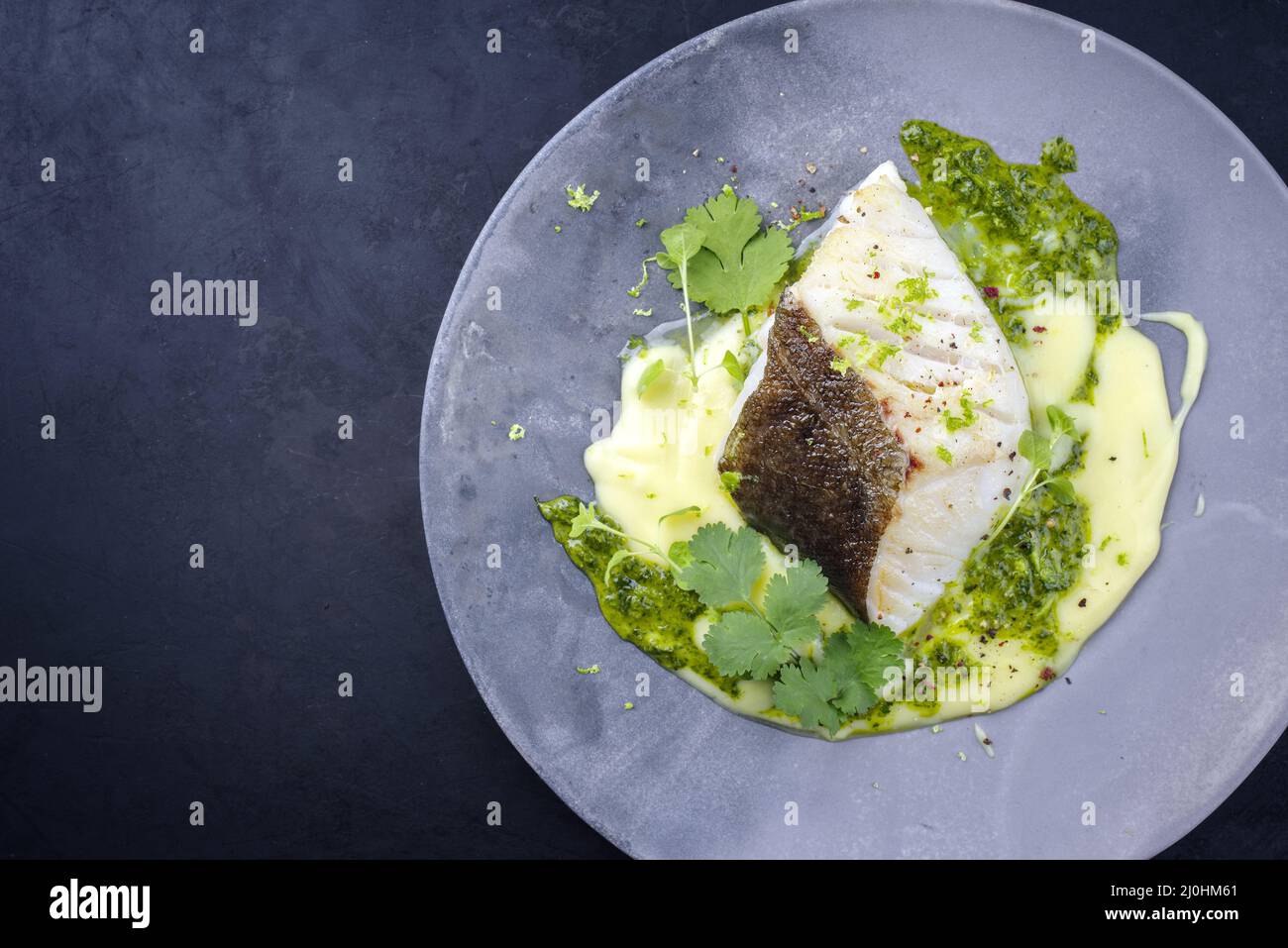 Modern style traditional fried skrei cod fish filet with mashed potato