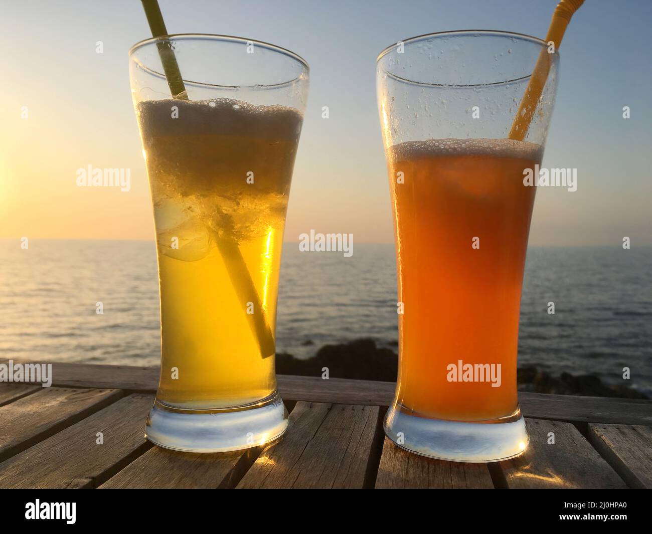 Frozen cocktail glasses over sunset Stock Photo