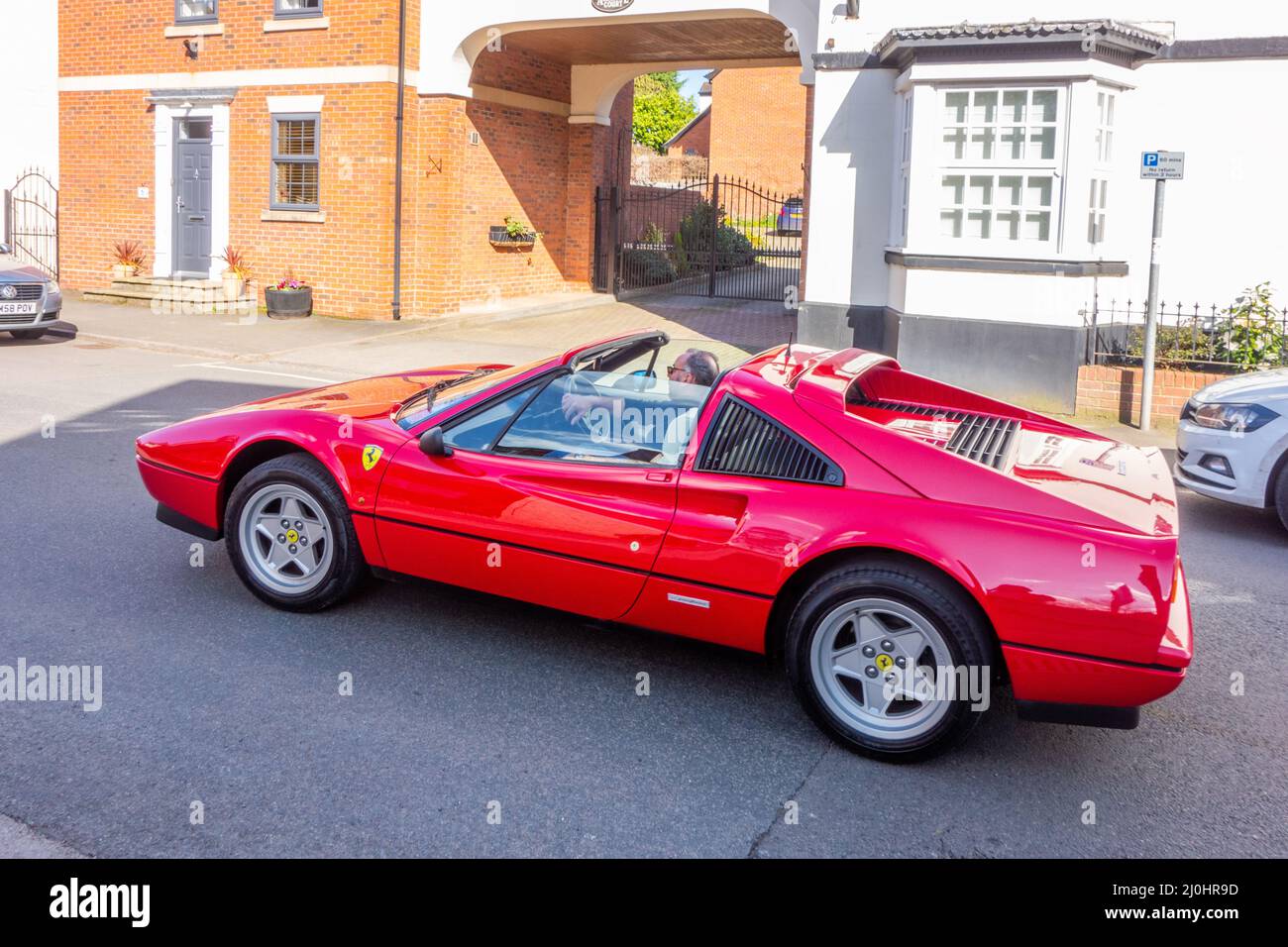 Red Ferrari car in the Cheshire village of Audlem Stock Photo