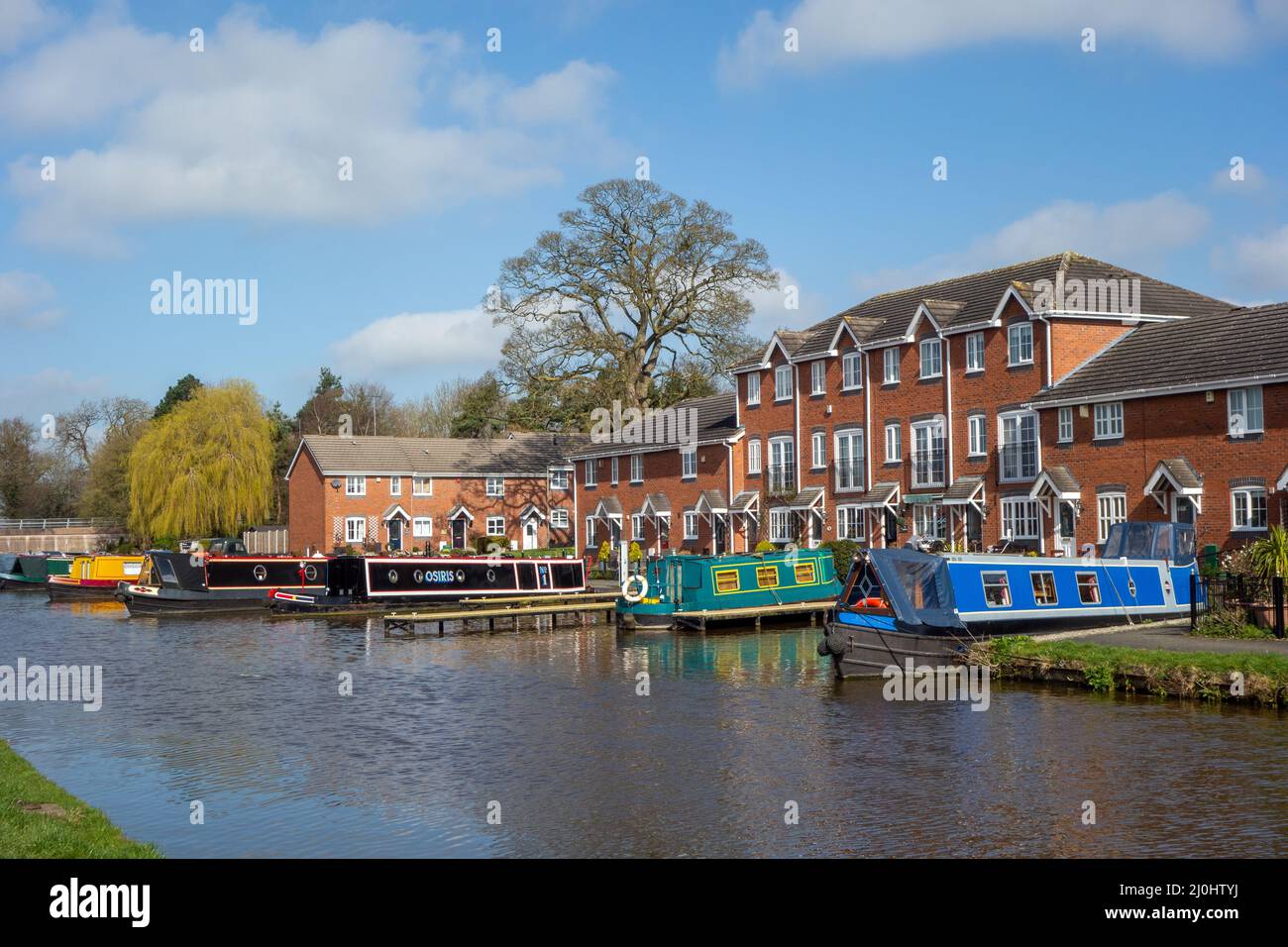 Canal narrowboats moored on the Shropshire union canal alongside a new