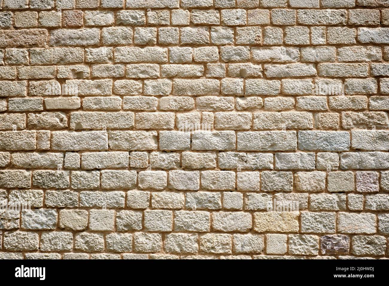 Background from a regular natural old stone wall Stock Photo