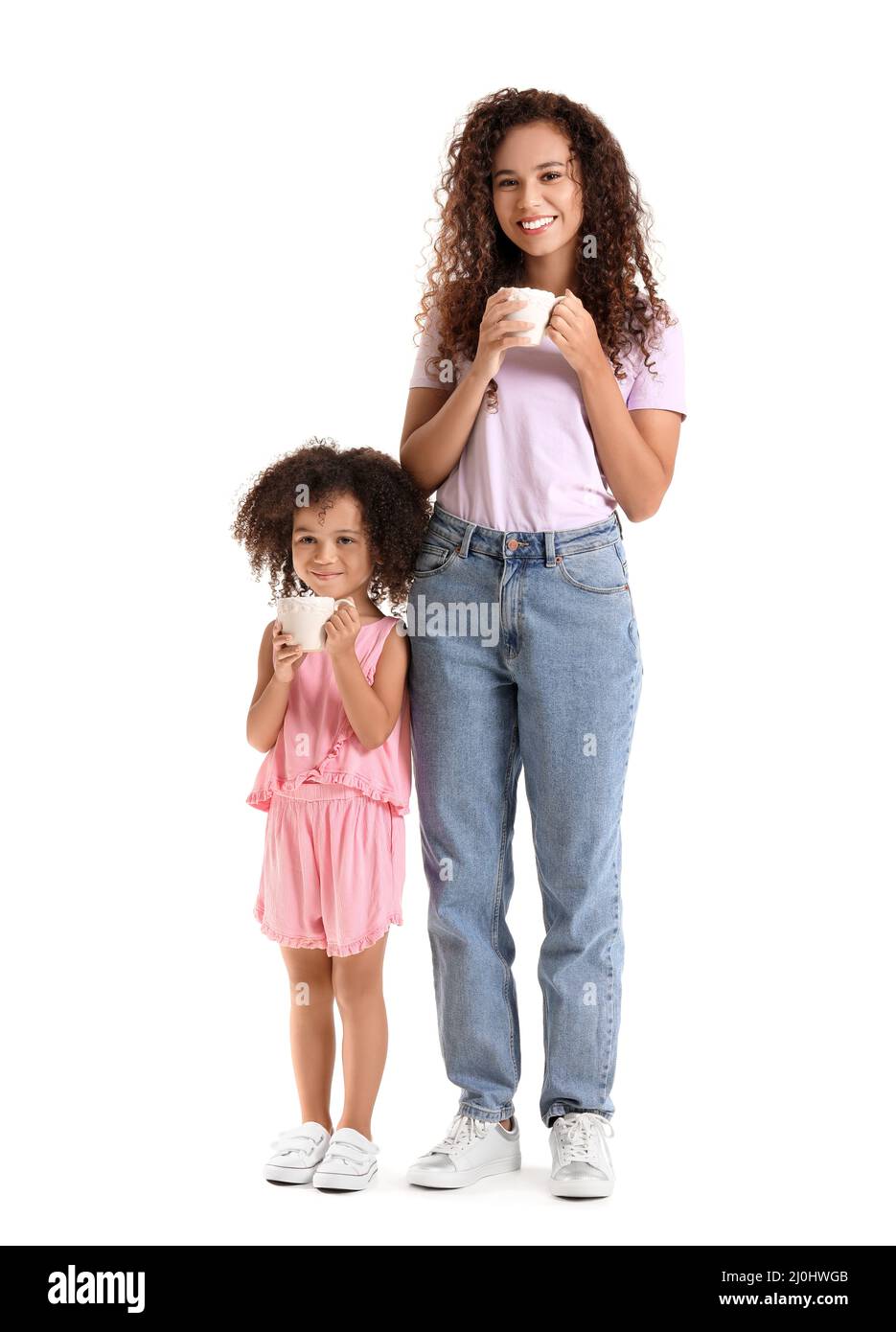 Little African-American girl and her mother with cups of hot cocoa on white background Stock Photo