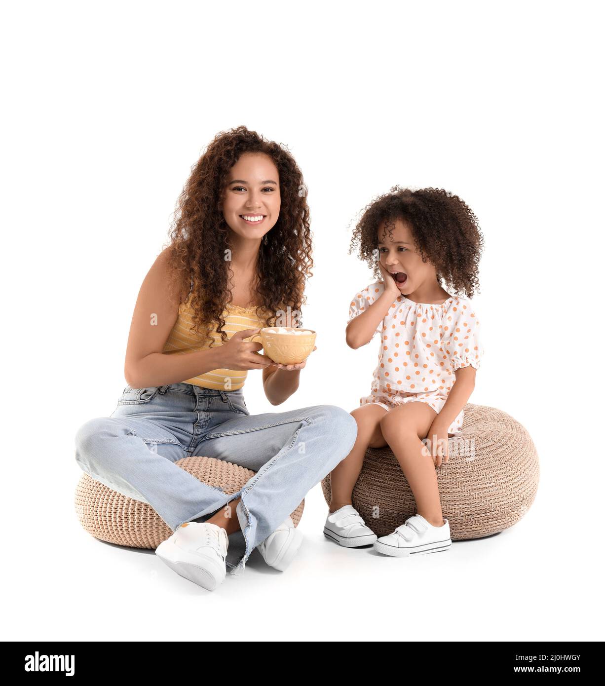 Little African-American girl and her mother with cup of hot cocoa on white background Stock Photo