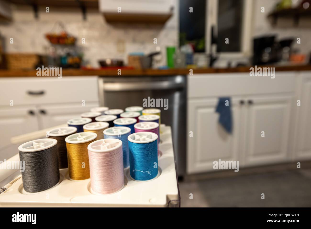 organized sewing thread in a white kitchen Stock Photo - Alamy