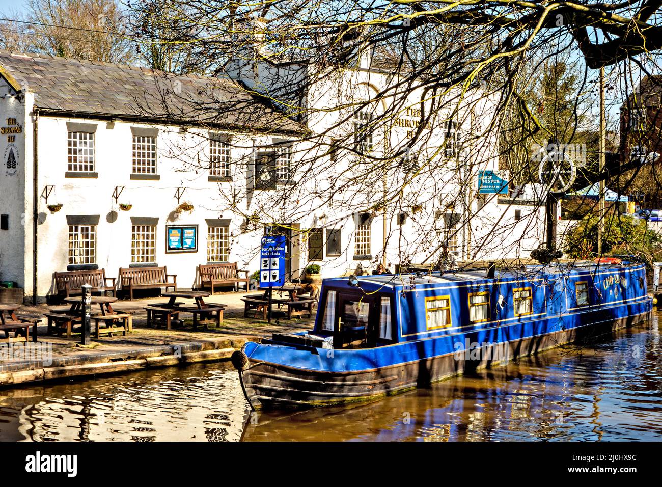 Canal narrowboat moored outside the Shroppie Fly pub on the Shropshire union canal at Audlem Cheshire England Stock Photo