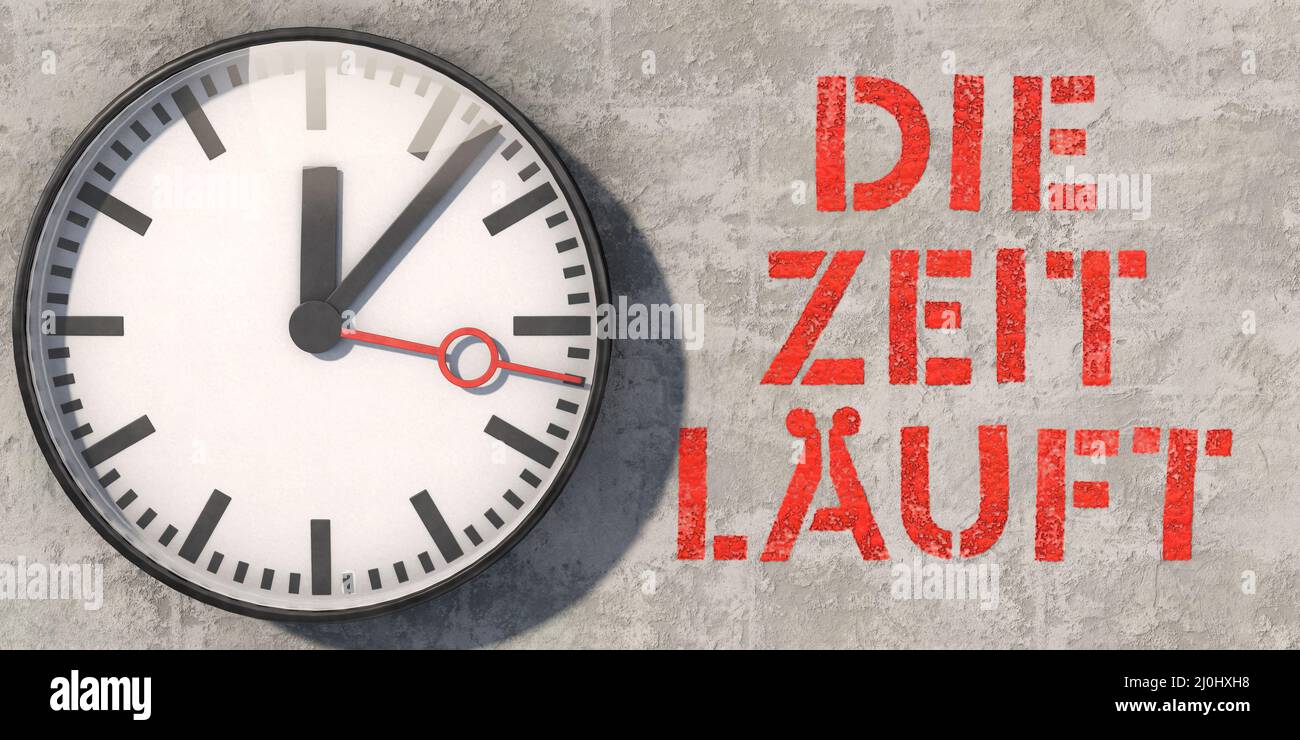 Wall clock on concrete wall with German lettering: Die Zeit lÃ¤uft (Time is running) Stock Photo