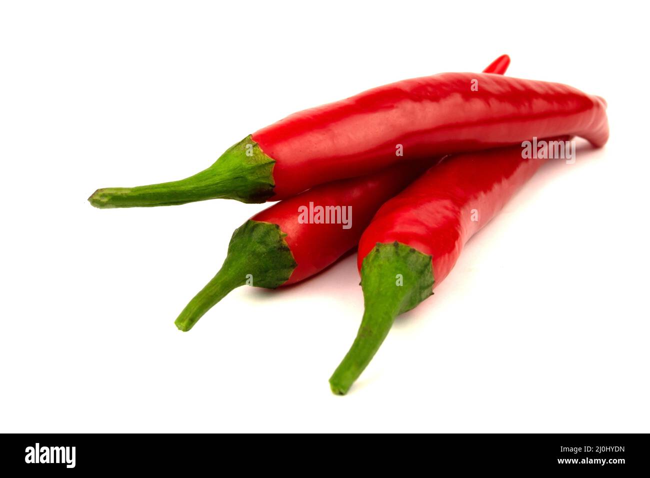 Three Chili peppers isolated on a white background Stock Photo - Alamy