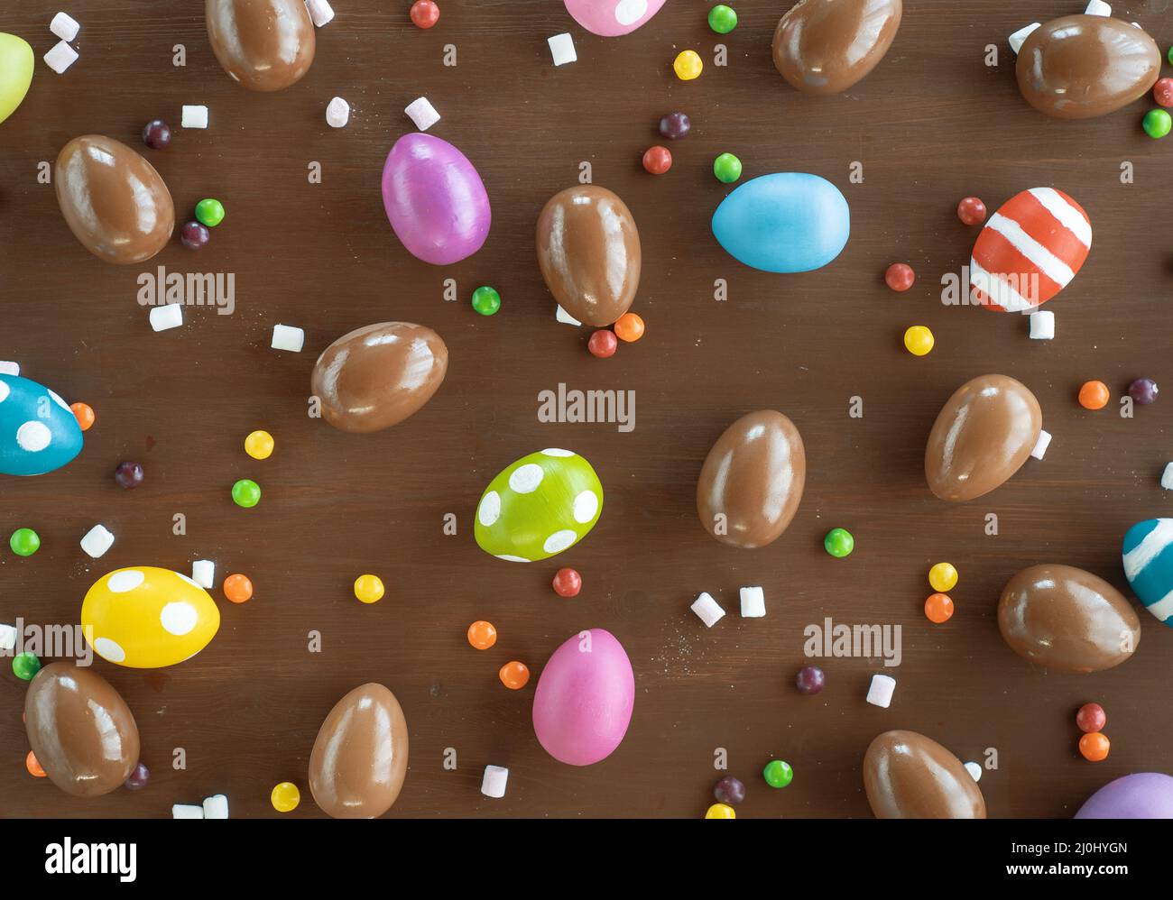Easter holiday background. Chocolate eggs and colorful sprinkle. Top ...