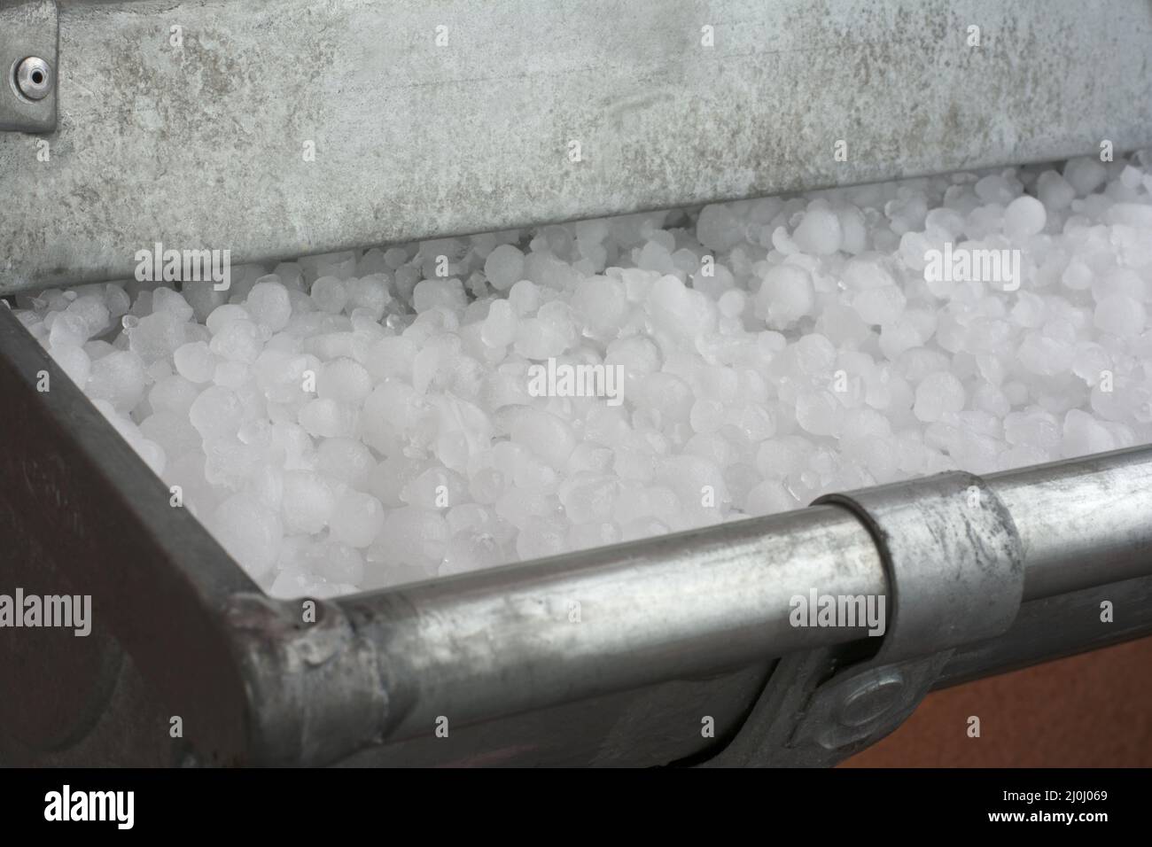 Hailstones in gutter Stock Photo