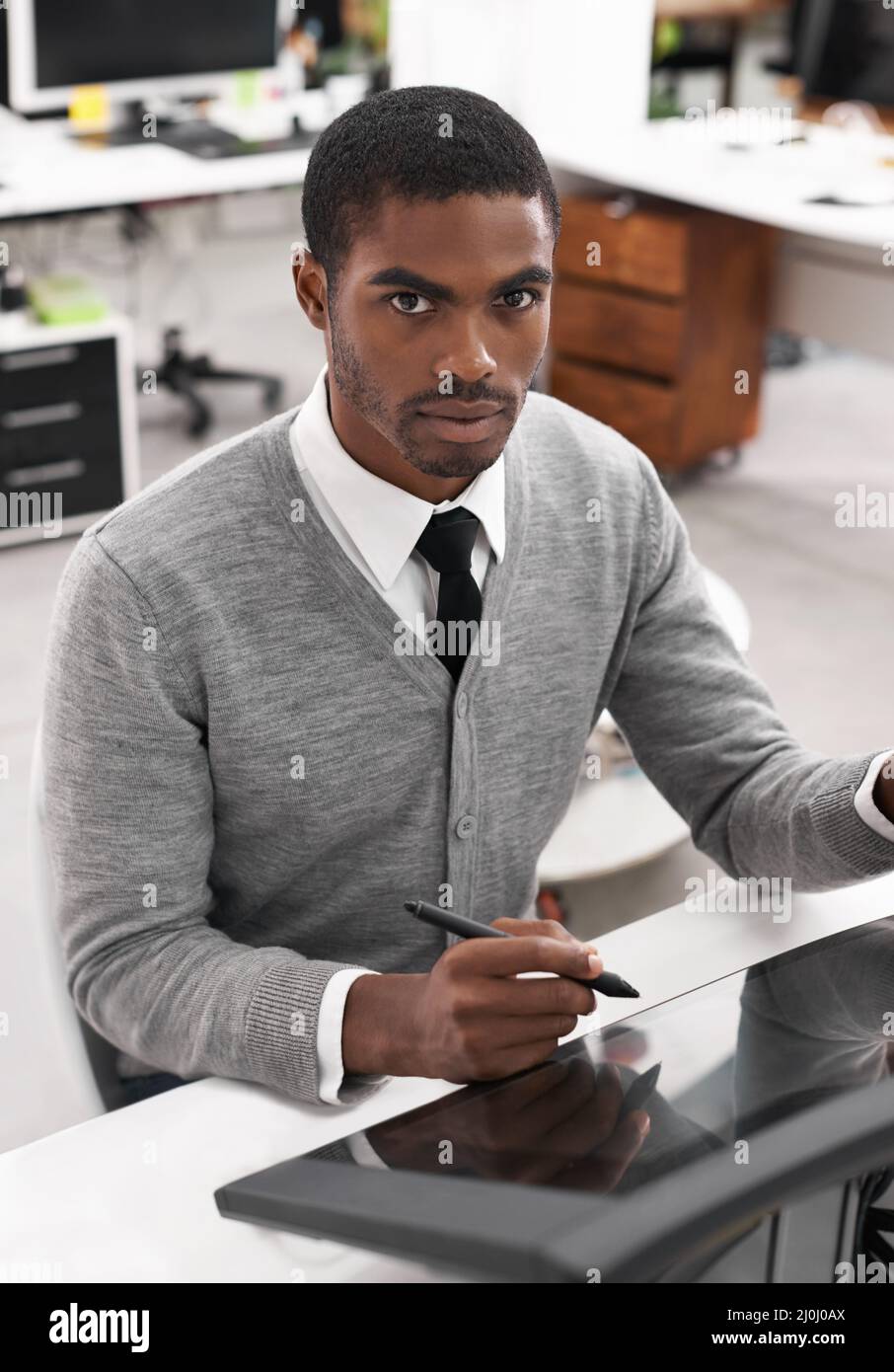 Smart technology makes everything easier. A young man working on a large touchscreen. Stock Photo