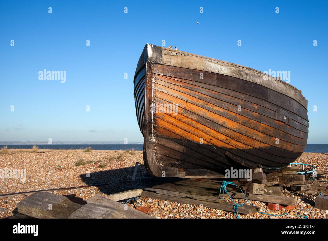 DUNGENESS, KENT, UK - DECEMBER 17 :  Beached Rowing Boat at Dungeness in Kent on December 17, 2008 Stock Photo