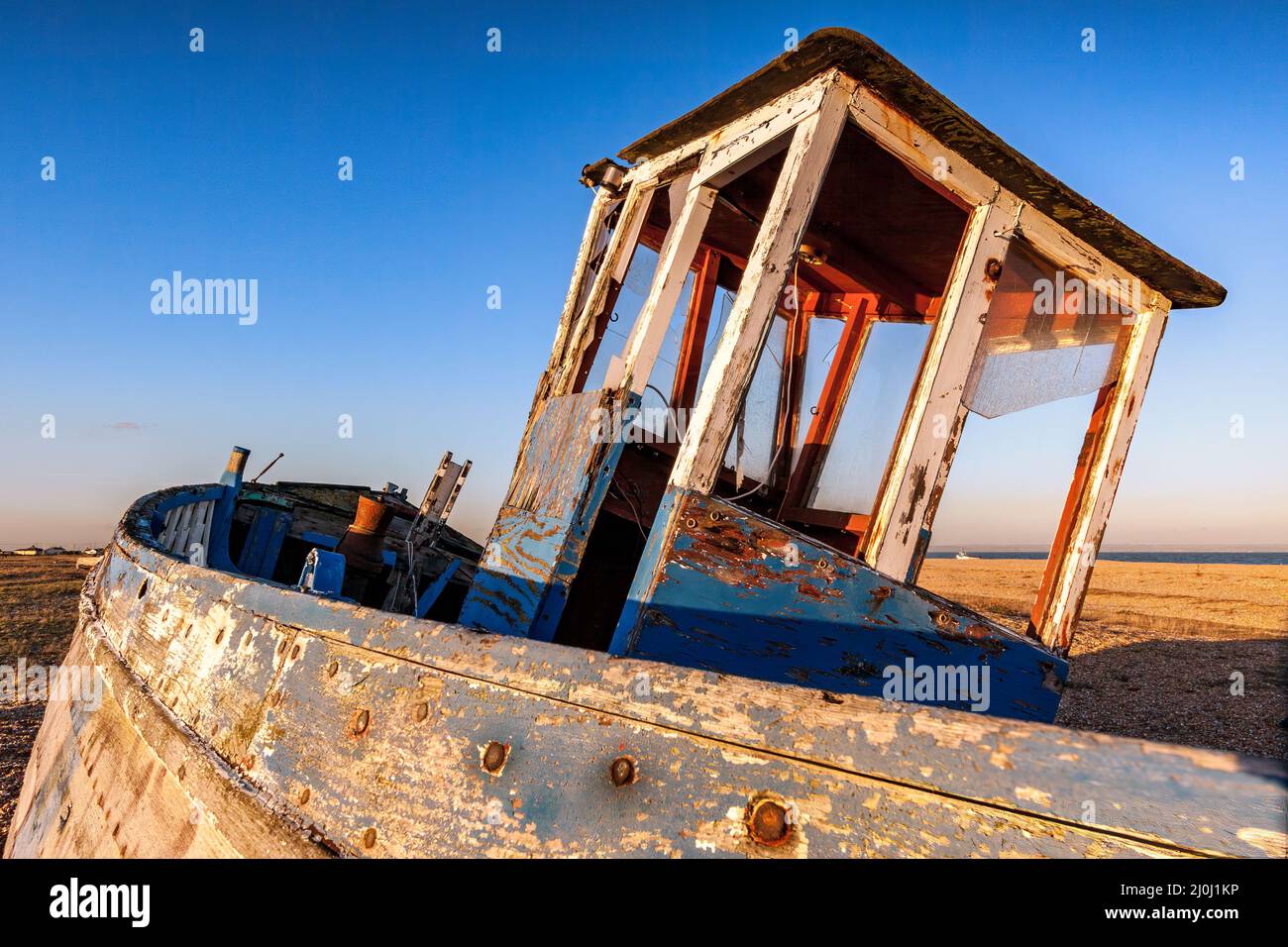DUNGENESS, KENT. UK - DECEMBER 17 :  Derelict Fishing Boat on Dungeness Beach in Kent on December 17, 2008 Stock Photo