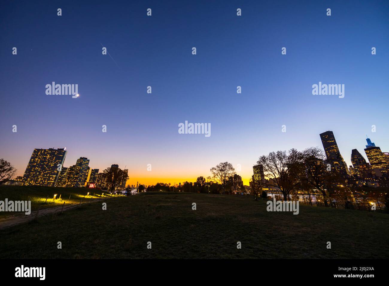 Sunset glow wraps the Midtown Manhattan skyscraper in the right hand side of the East River and