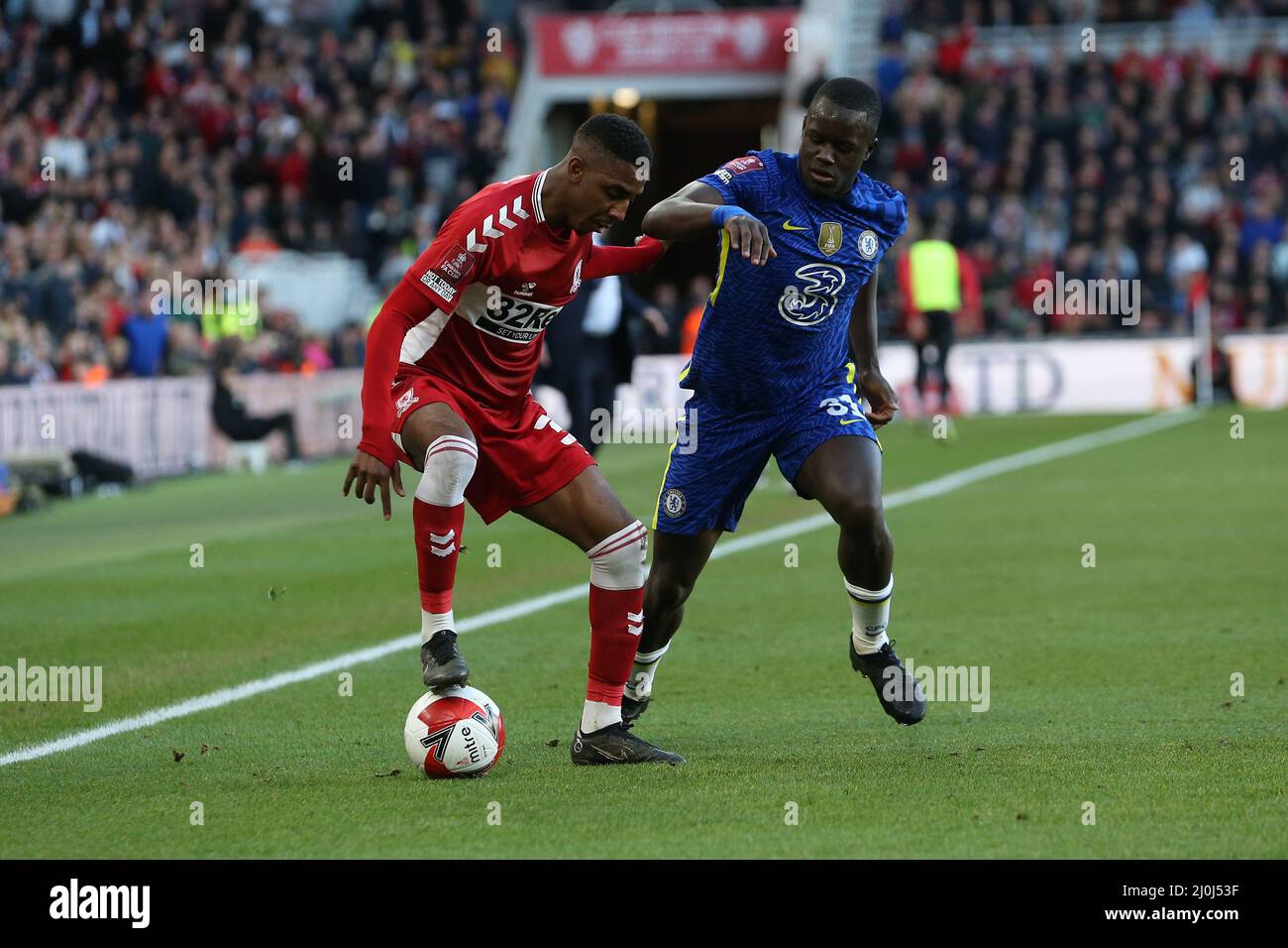 MIDDLESBROUGH, UK. MAR 19TH Middlesbrough's Isaiah Jones battles for possession with Chelsea's Malang Sarr during the FA Cup match between Middlesbrough and Chelsea at the Riverside Stadium, Middlesbrough on Saturday 19th March 2022. (Credit: Mark Fletcher | MI News) Credit: MI News & Sport /Alamy Live News Stock Photo