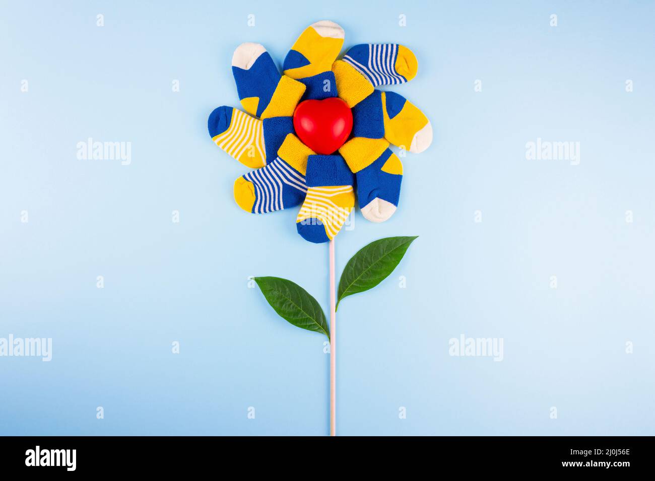 World Down Syndrome Day background. Different socks with heart on blue