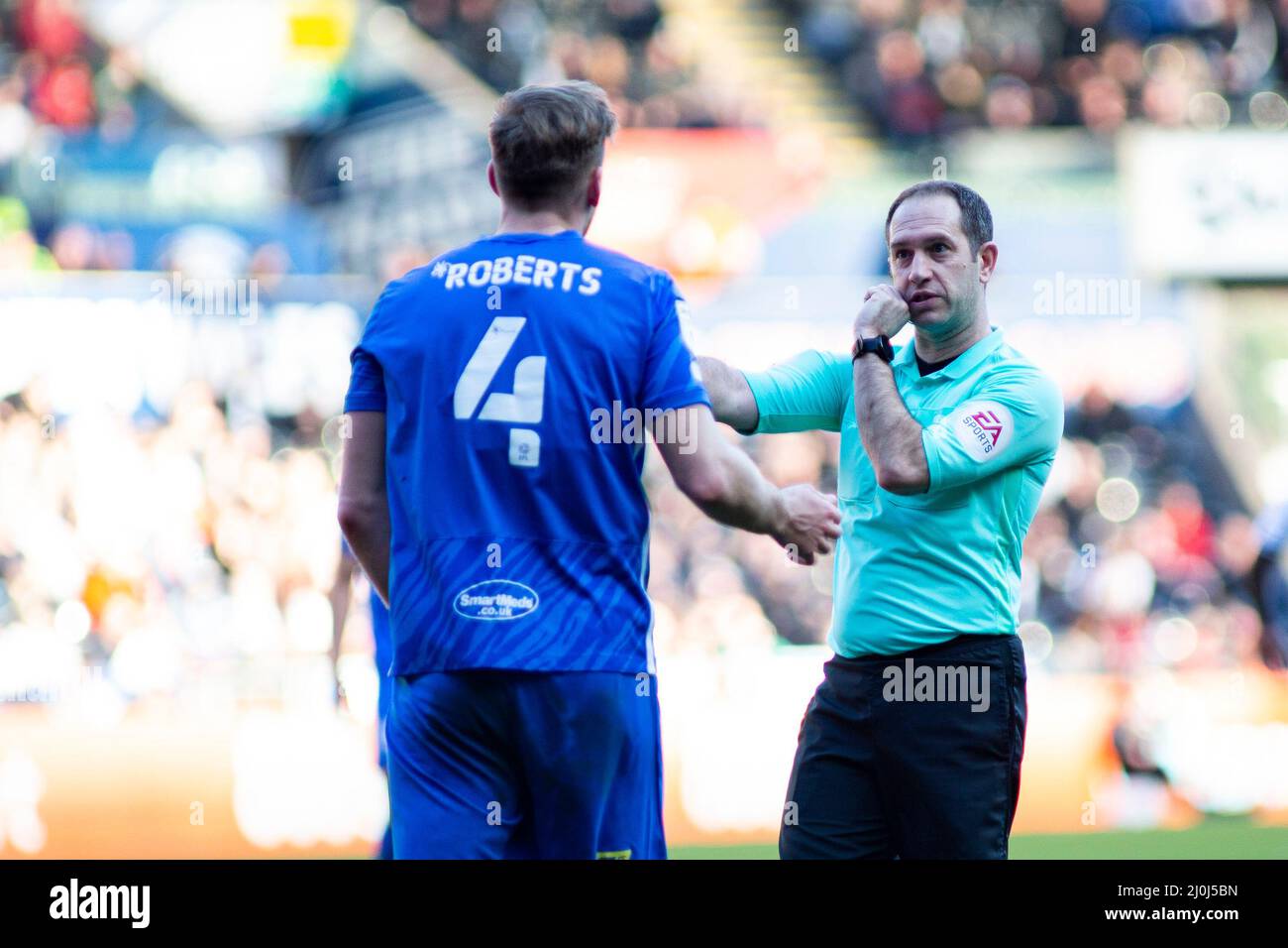 Swansea, UK. 19th Mar, 2022. Match Referee Jeremy Simpson (R) talks to Marc Roberts of Birmingham City (L) EFL Skybet championship match, Swansea city v Birmingham City at the Swansea.com Stadium in Swansea on Saturday 19th March 2022. this image may only be used for Editorial purposes. Editorial use only, license required for commercial use. No use in betting, games or a single club/league/player publications. pic by Lewis Mitchell/Andrew Orchard/Andrew Orchard sports photography/Alamy Live news Credit: Andrew Orchard sports photography/Alamy Live News Stock Photo